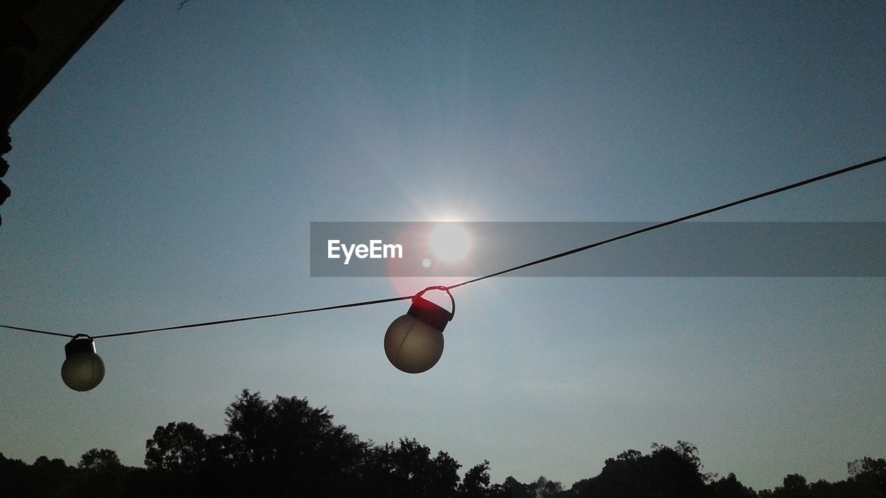 Light bulb with sun in background