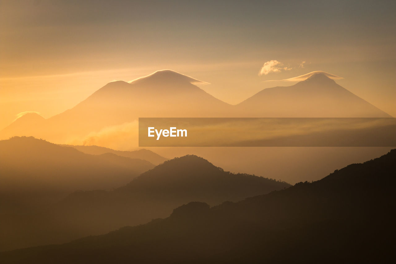 Scenic view of mountains against sky during sunset