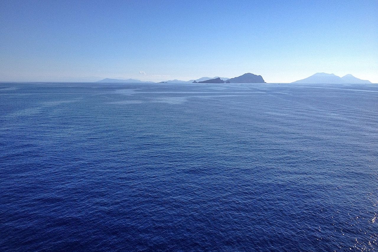 Scenic view of sea against clear blue sky