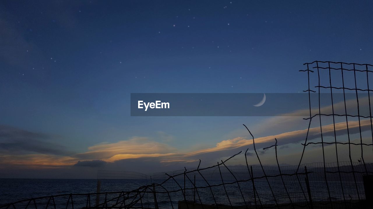 Scenic view of sea against sky at sunset