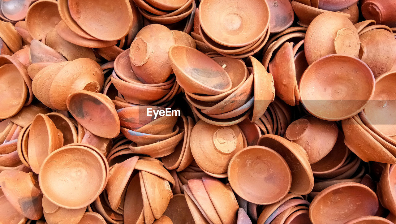 Close up of heap of indian clay oil lanterns or diya ready to be sold in market during diwali 