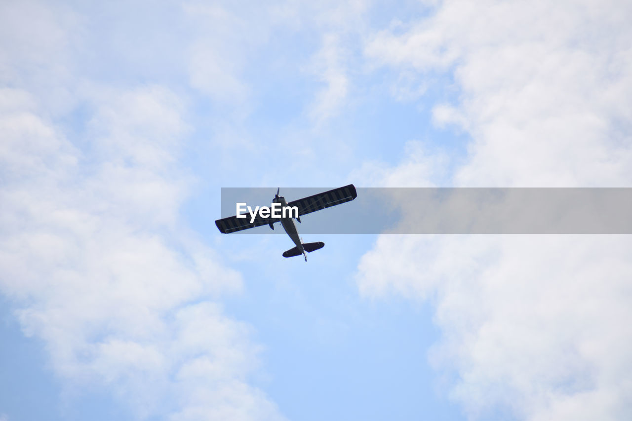 Low angle view of airplane against sky