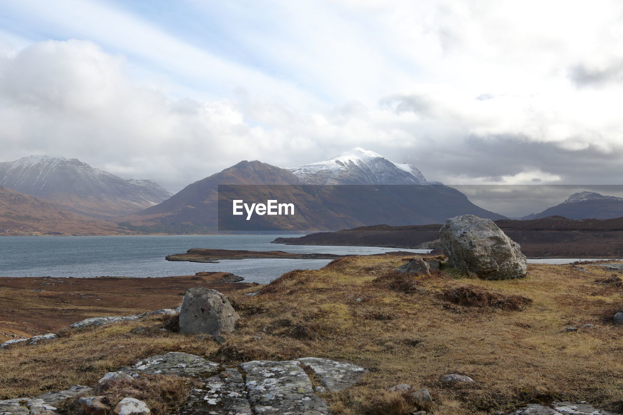 Scenic view of lake and mountains against sky