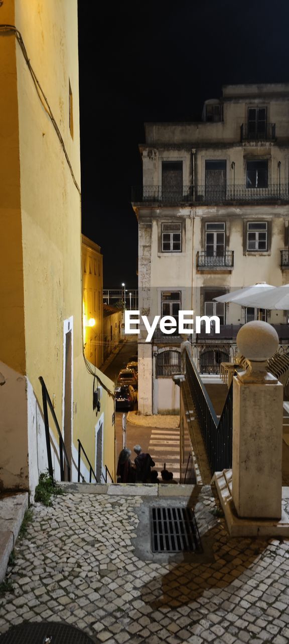 architecture, building exterior, built structure, city, urban area, night, street, building, cobblestone, no people, house, illuminated, nature, town, travel destinations, wall, ancient history, outdoors, lighting