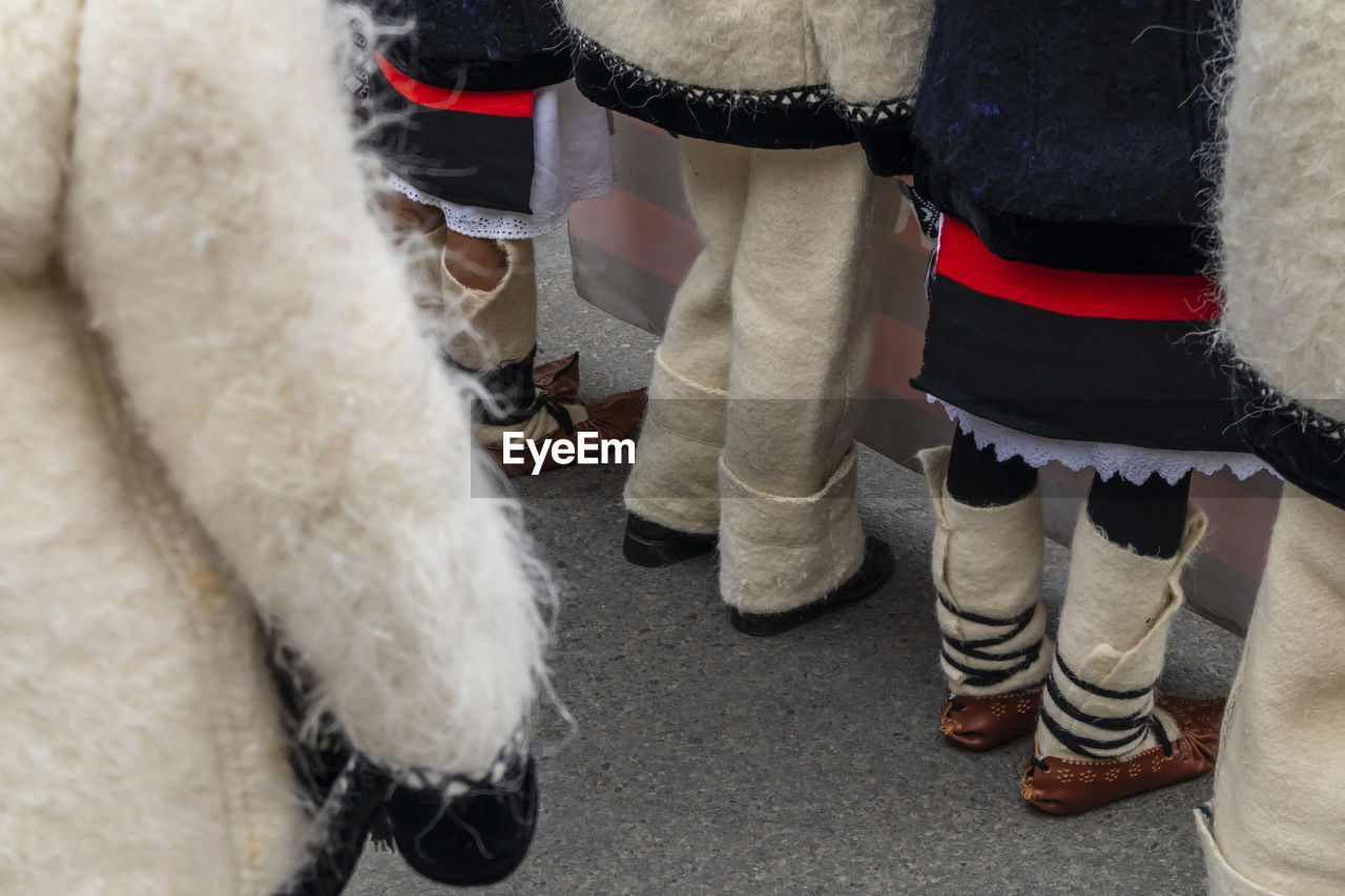 Rear view of people in warm clothing standing on street