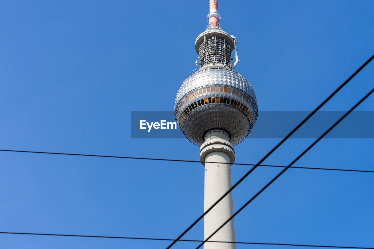 Low angle view of communications tower against sky