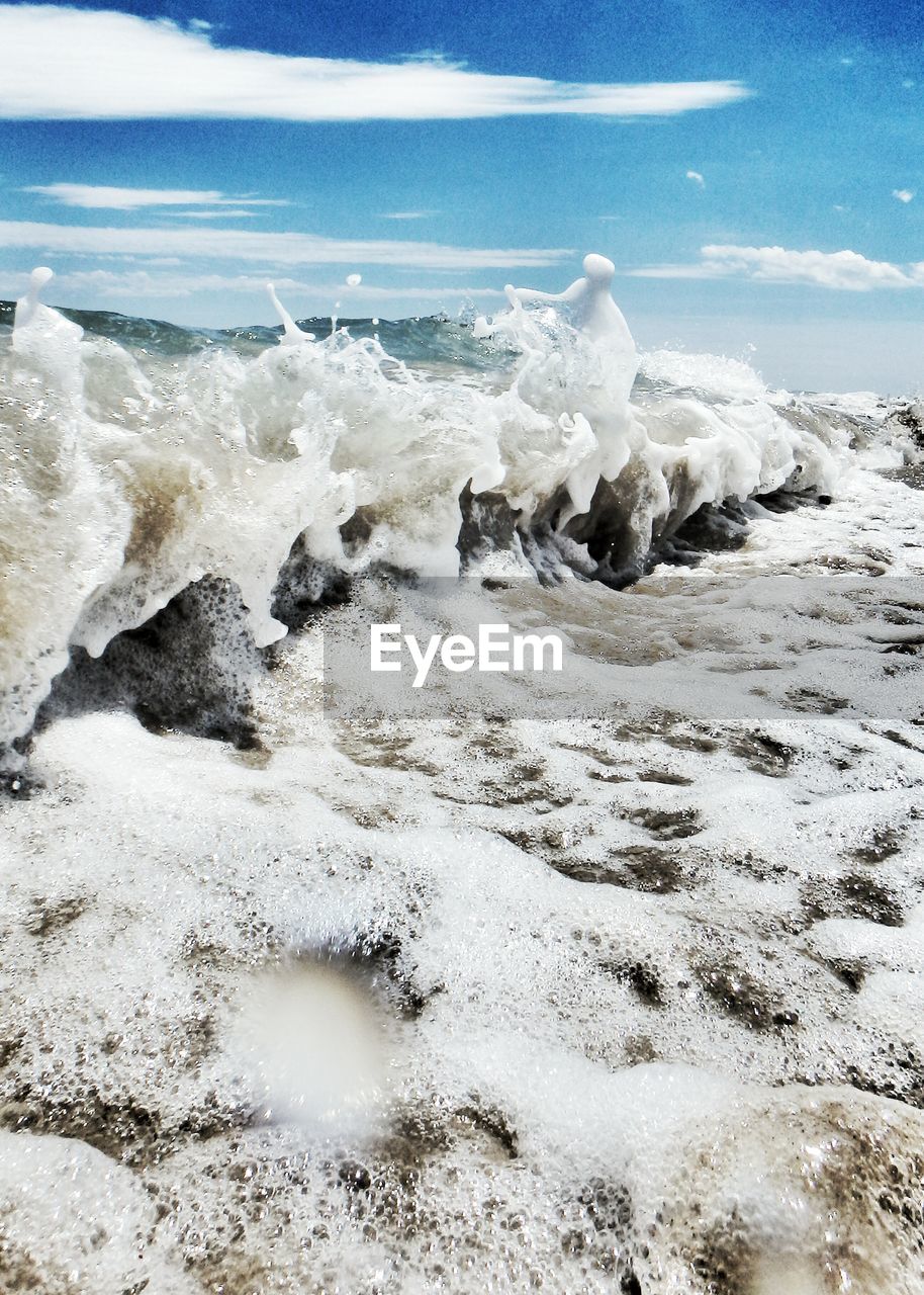 Scenic view of waves against sky