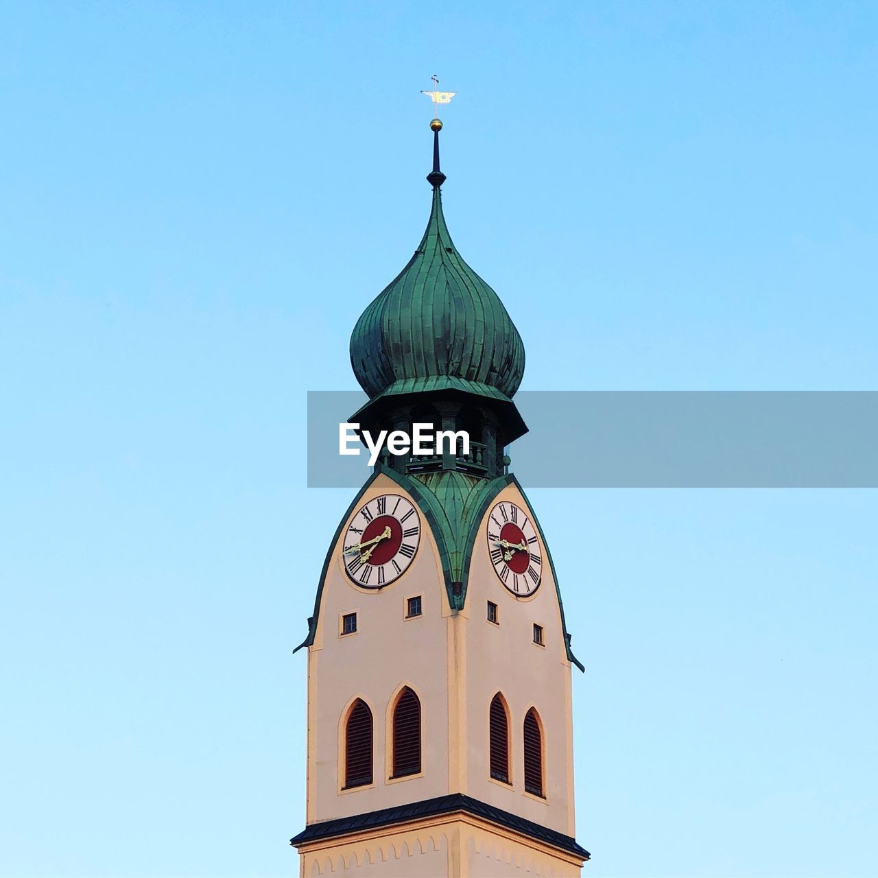Low angle view of clock tower against clear sky