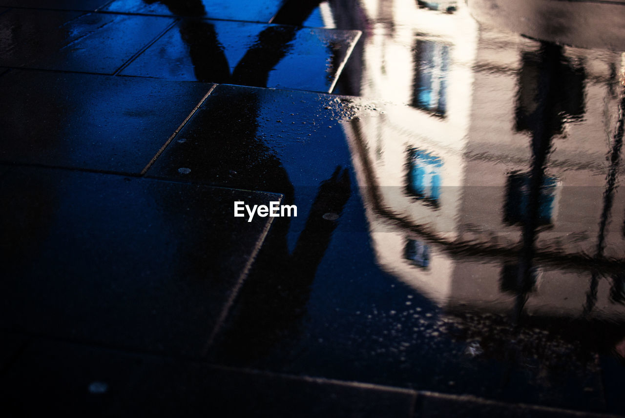 High angle view of reflection in puddle on street