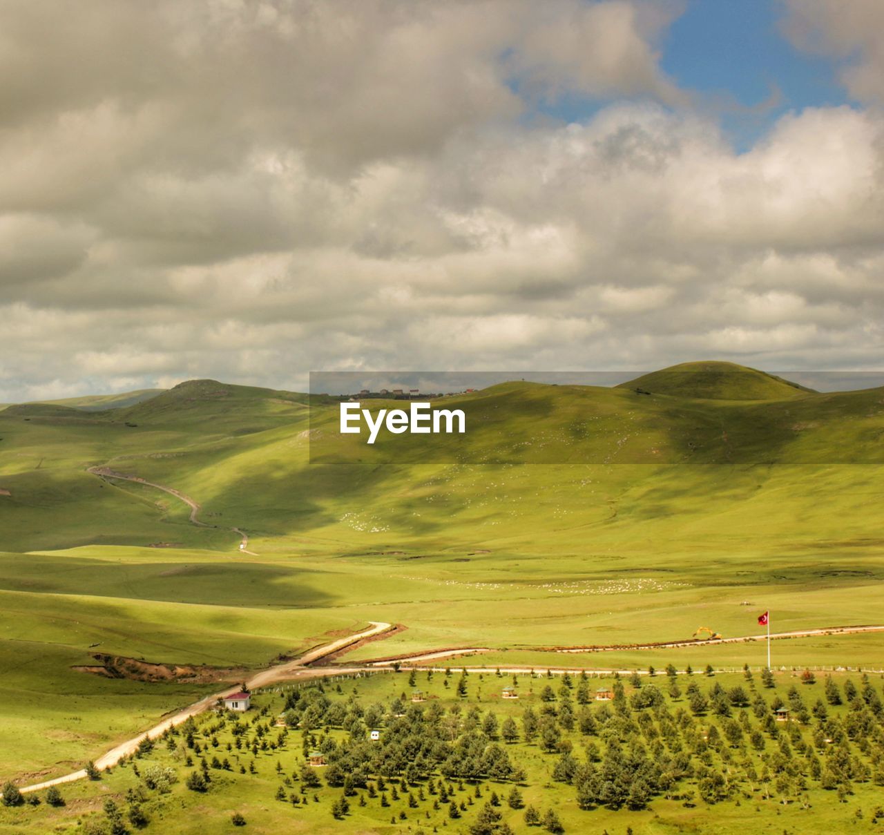 Rural scene against cloudy sky