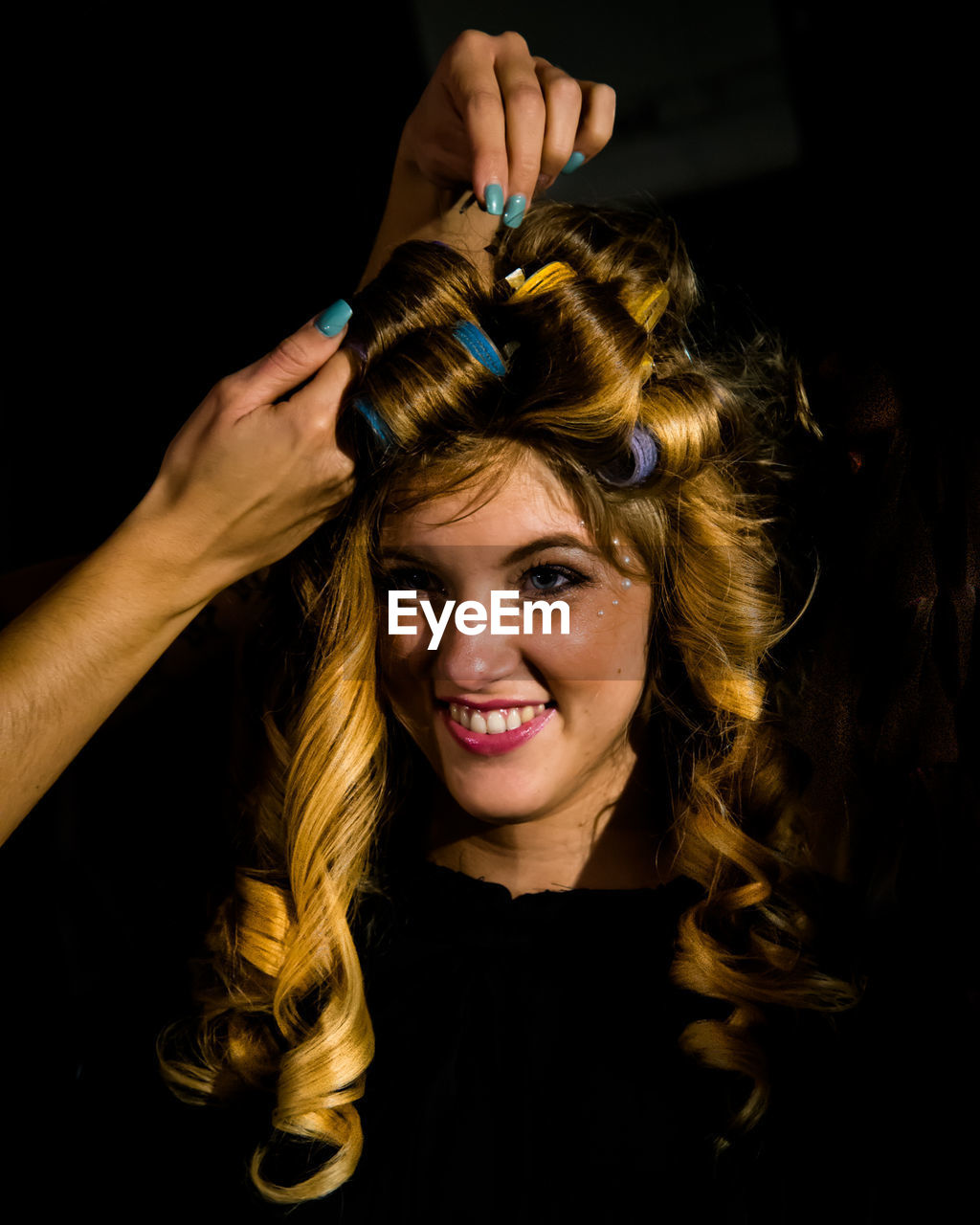 Portrait of young woman with hair curlers