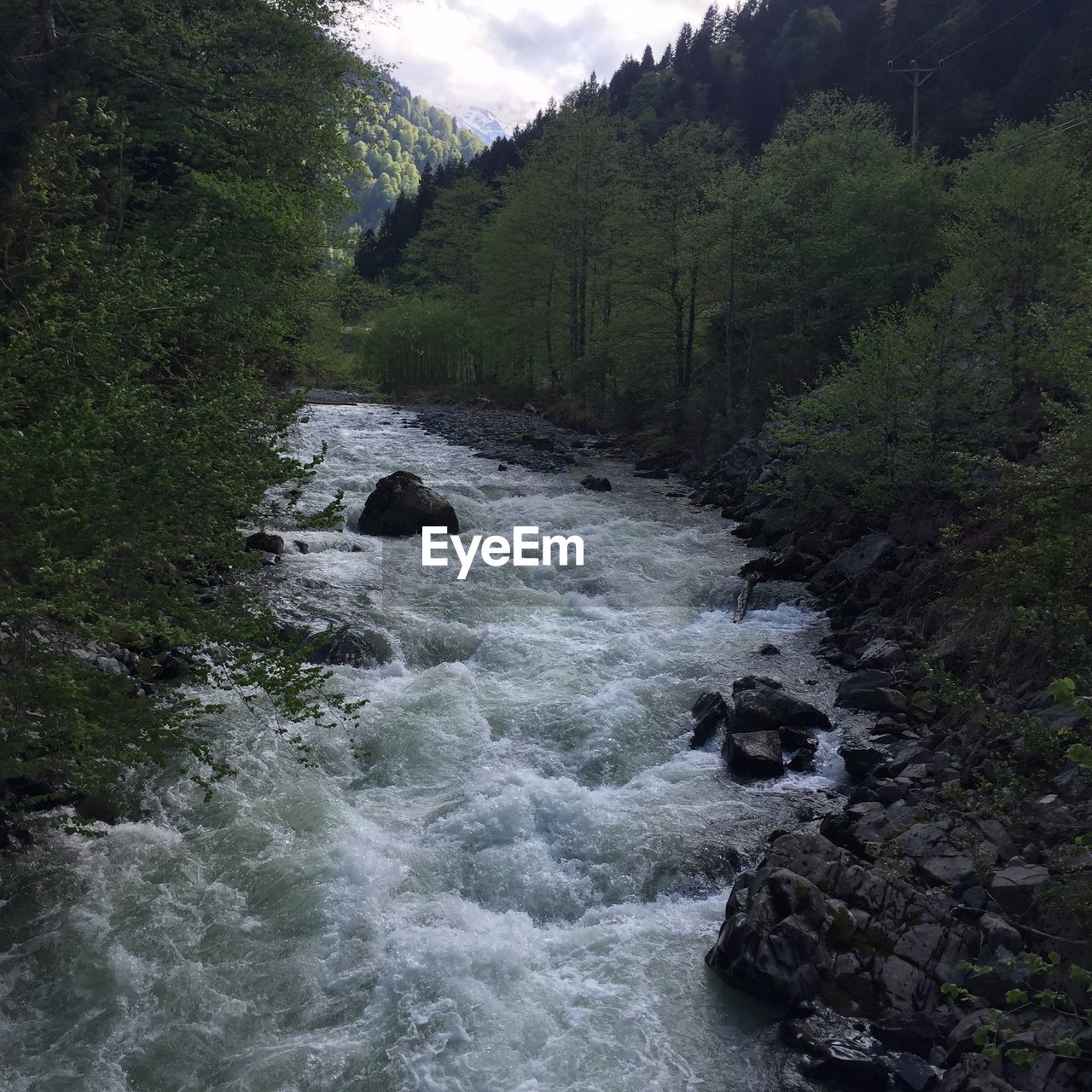 SCENIC VIEW OF RIVER FLOWING THROUGH ROCKS