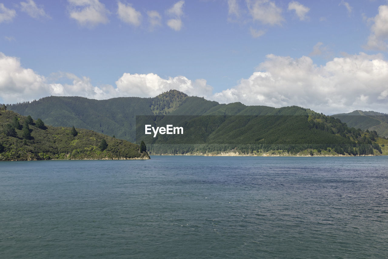 SCENIC VIEW OF MOUNTAINS AND SEA AGAINST SKY