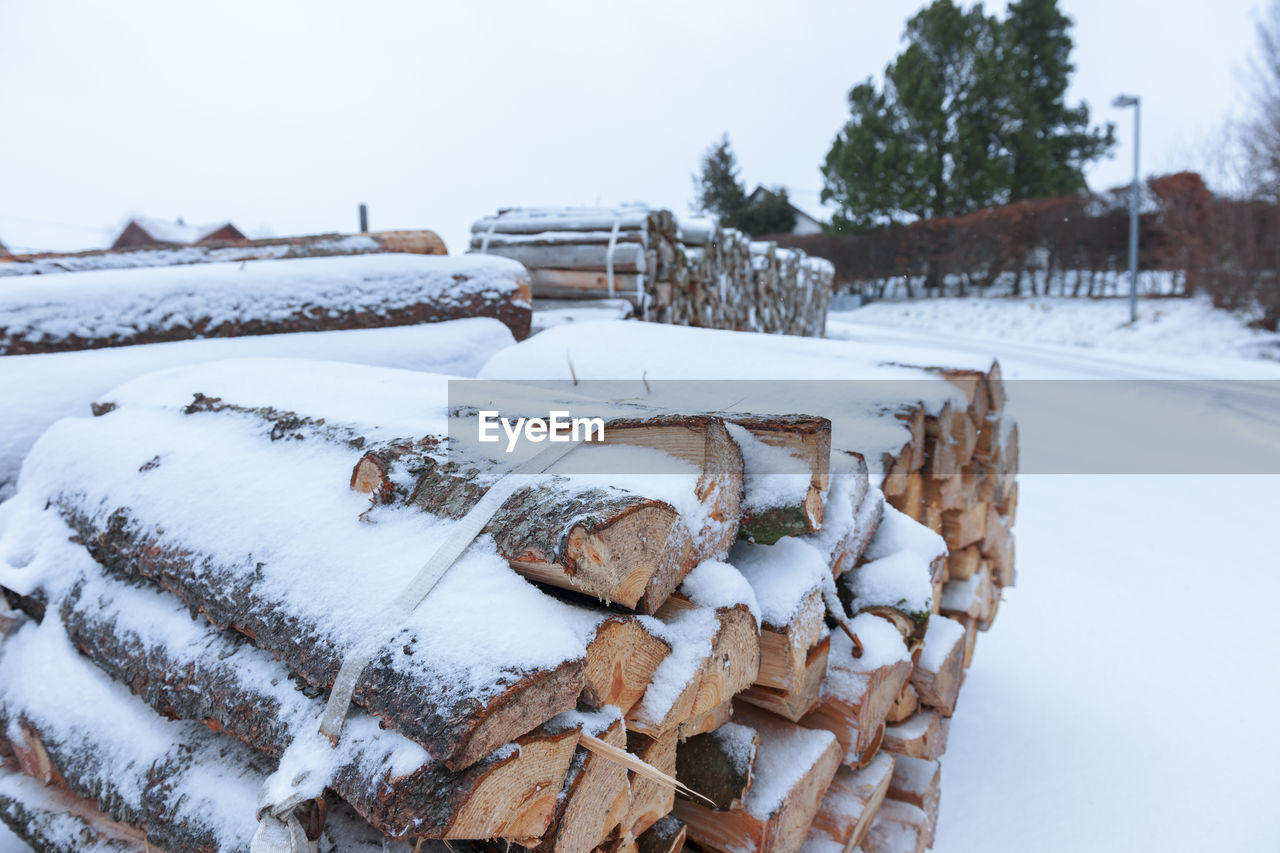 Wide angle view for transporting bundled firewood on a snowy mountain road.