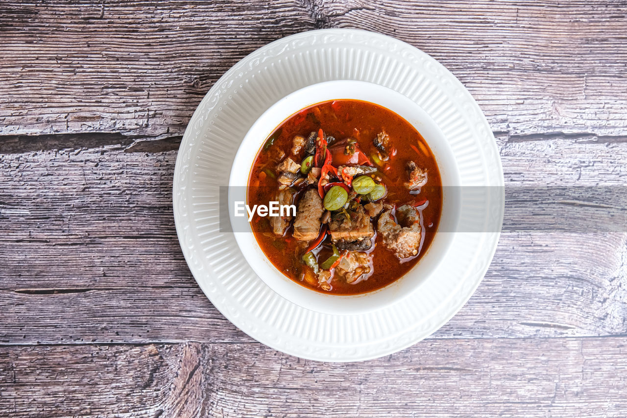 food and drink, food, healthy eating, wood, wellbeing, vegetable, dish, freshness, table, produce, bowl, directly above, plate, no people, soup, curry, meal, high angle view, meat, spice, garnish, indoors, crockery, serving size, red curry, still life, cuisine, stew