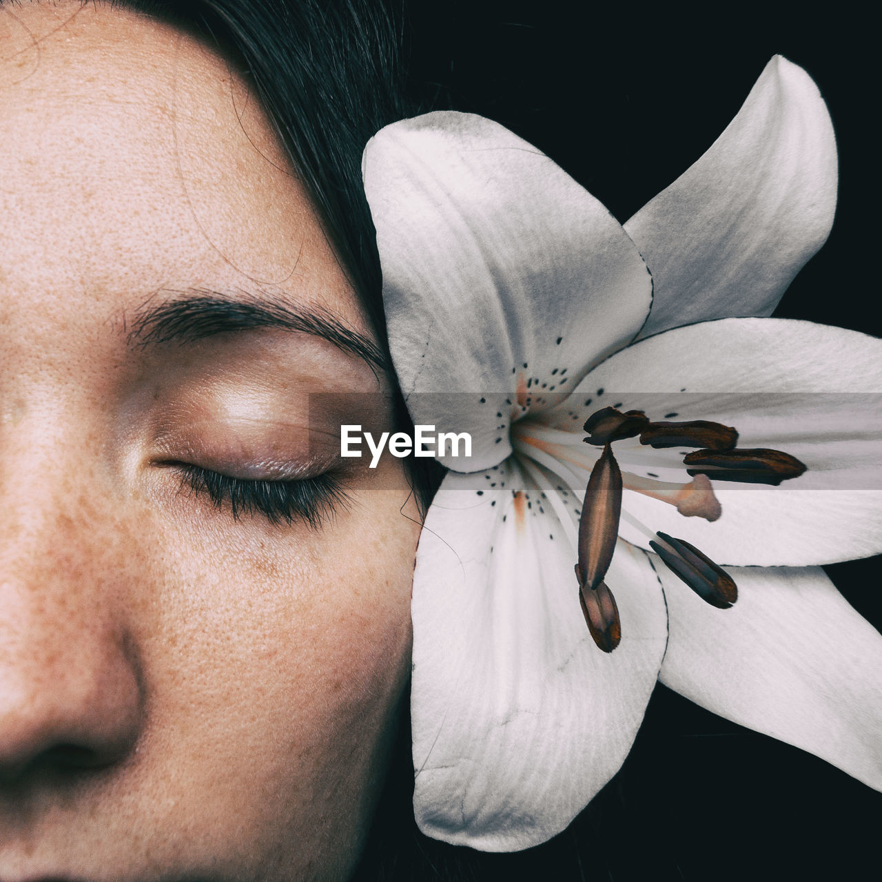 Close-up of woman wearing flower