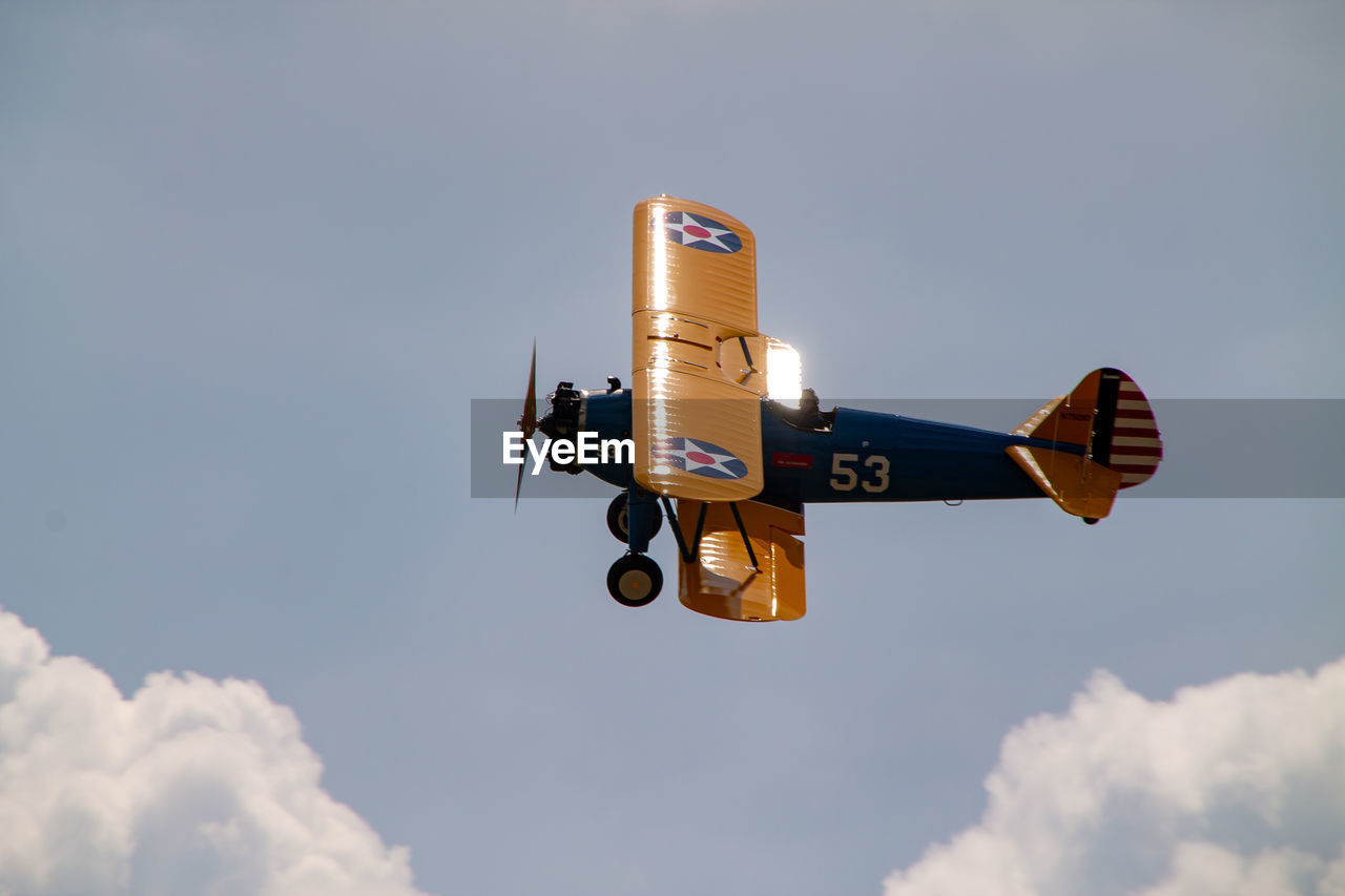 Low angle view of airplane flying against sky