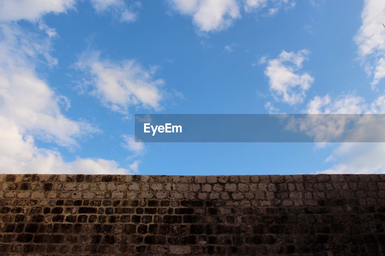 Low angle view of wall against sky