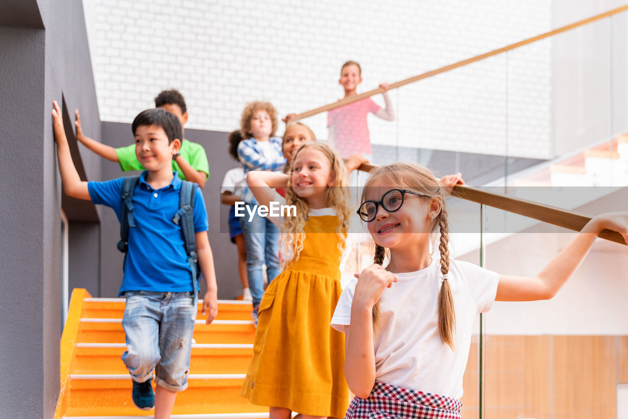 Low angle view of kids standing on staircase