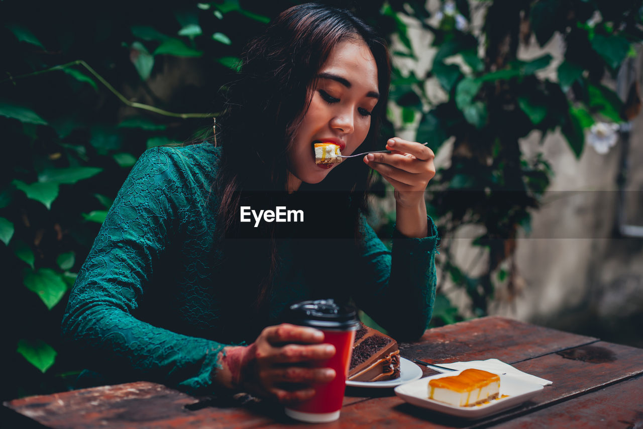 Woman having dessert at table