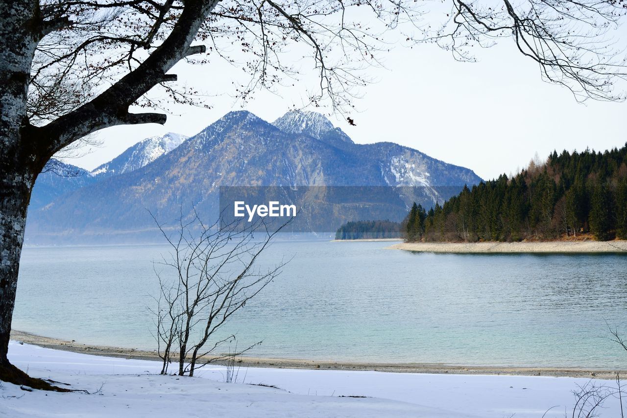 Scenic view of landscape and mountains against blue sky