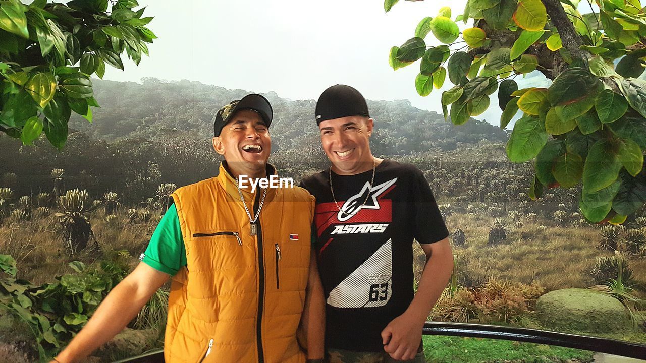 YOUNG COUPLE STANDING ON MOUNTAIN