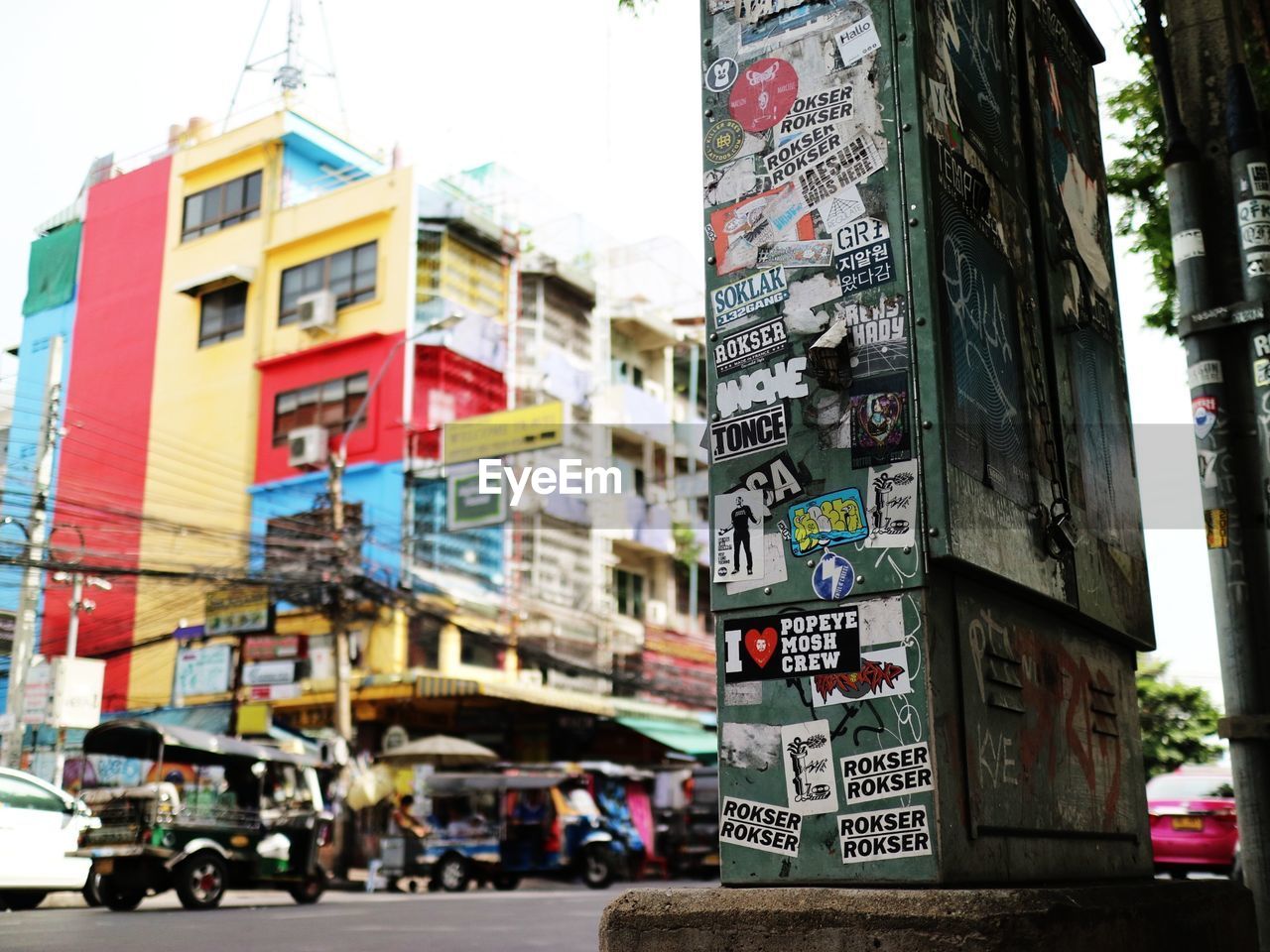 VEHICLES ON ROAD AGAINST BUILDINGS