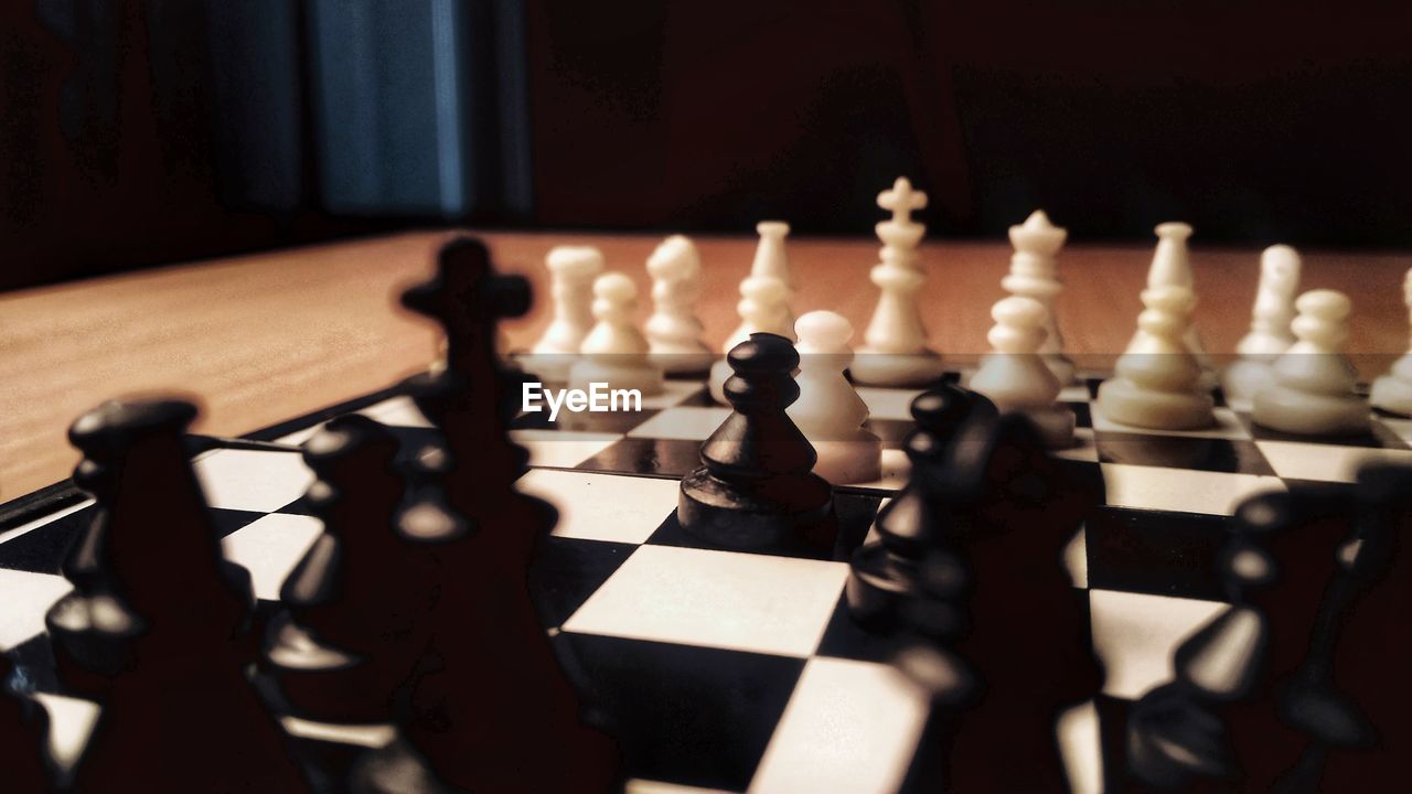 Close-up of chess pieces on table