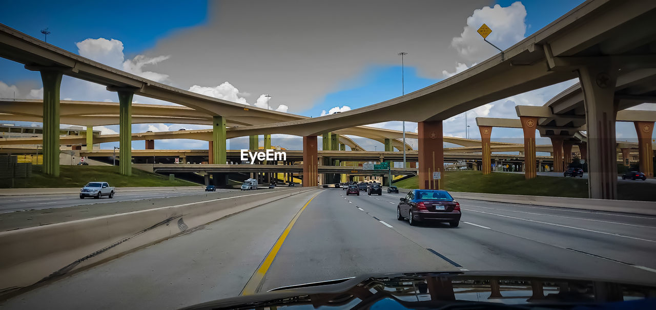 VEHICLES ON ROAD SEEN THROUGH CAR WINDSHIELD