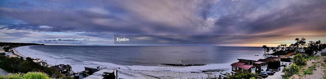 Panoramic view of beach against sky during sunset