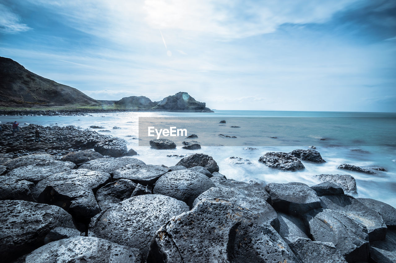 Rocks in sea against sky