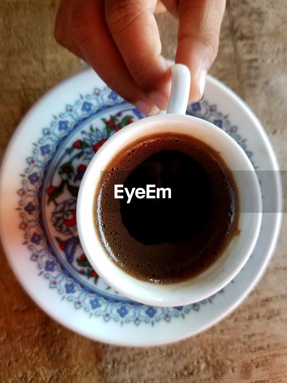 CLOSE-UP OF COFFEE CUP ON TABLE