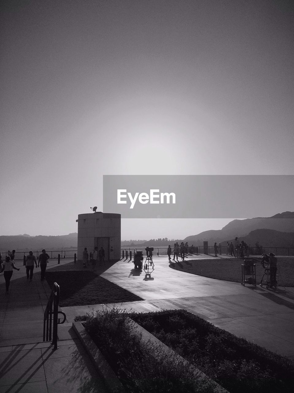 People walking in park at sunset