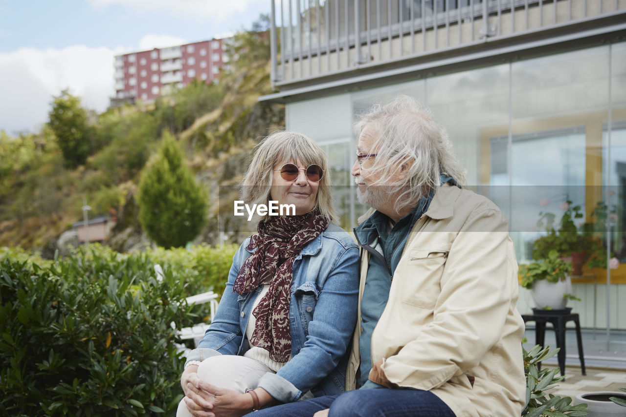 Smiling senior couple sitting outdoors