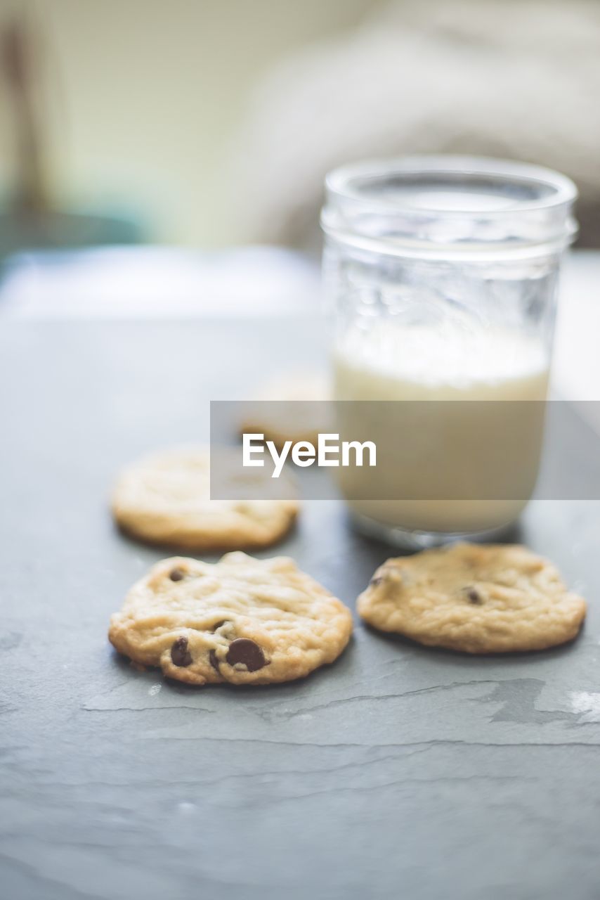 CLOSE-UP OF COOKIES IN CUP ON TABLE