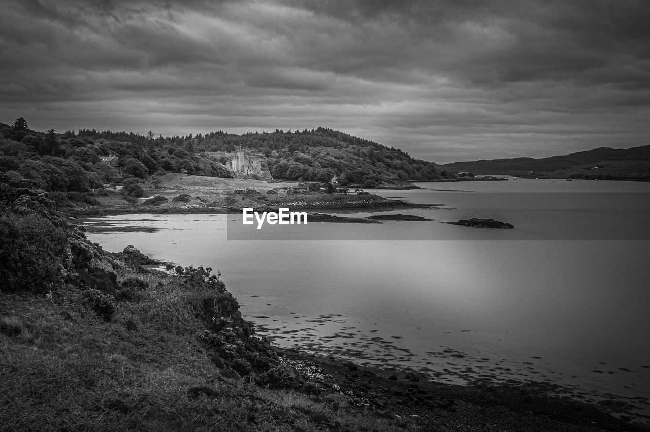 Black and white panorama of the bay of dunvegan loch with dunvegan castle