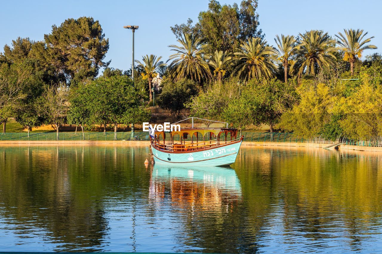 BOAT MOORED IN LAKE