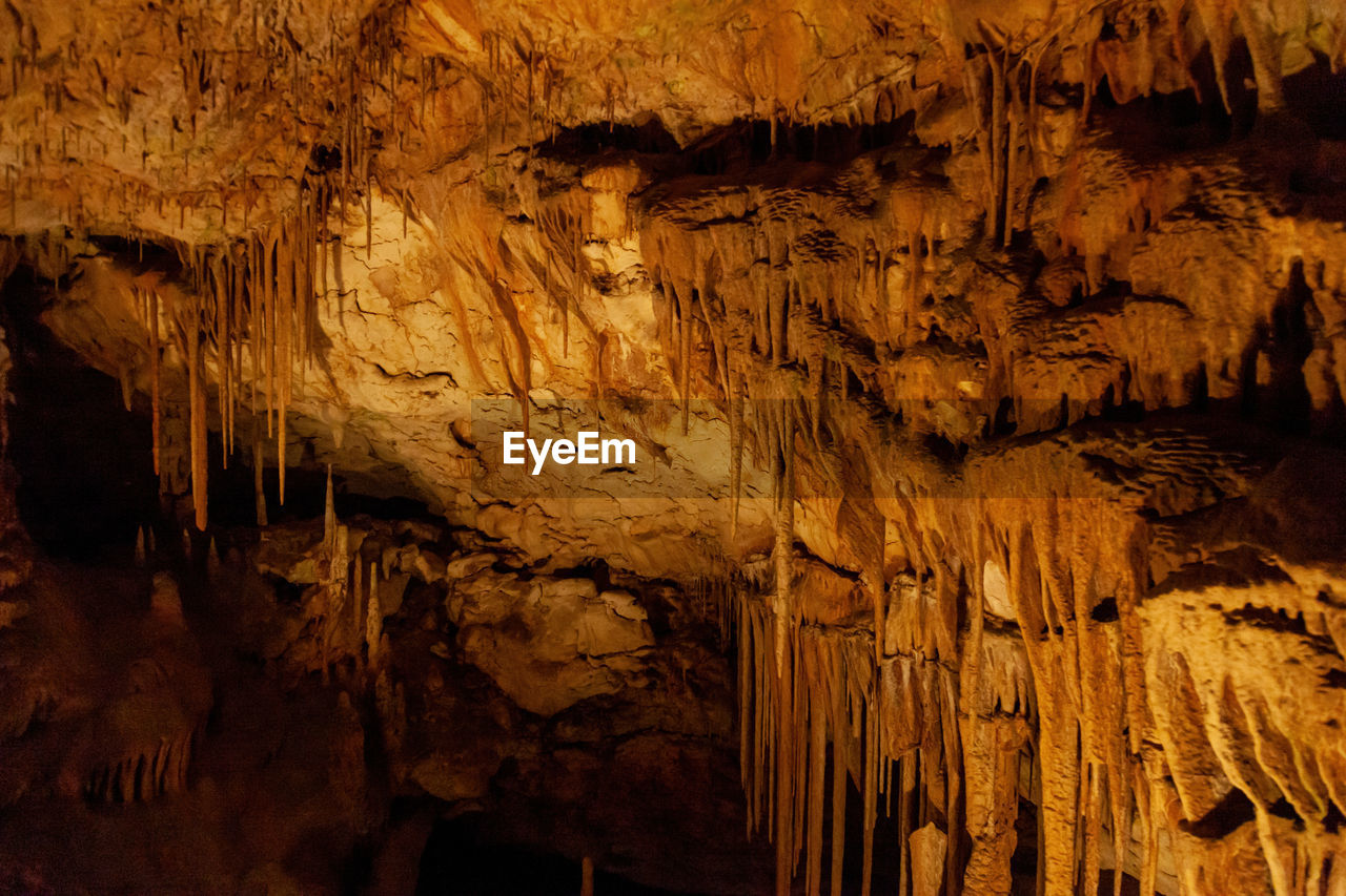 stalactite, geology, cave, stalagmite, rock, rock formation, physical geography, speleothem, no people, indoors, pattern, nature, beauty in nature, textured, low angle view, limestone, rough, travel destinations, non-urban scene, discovery, brown