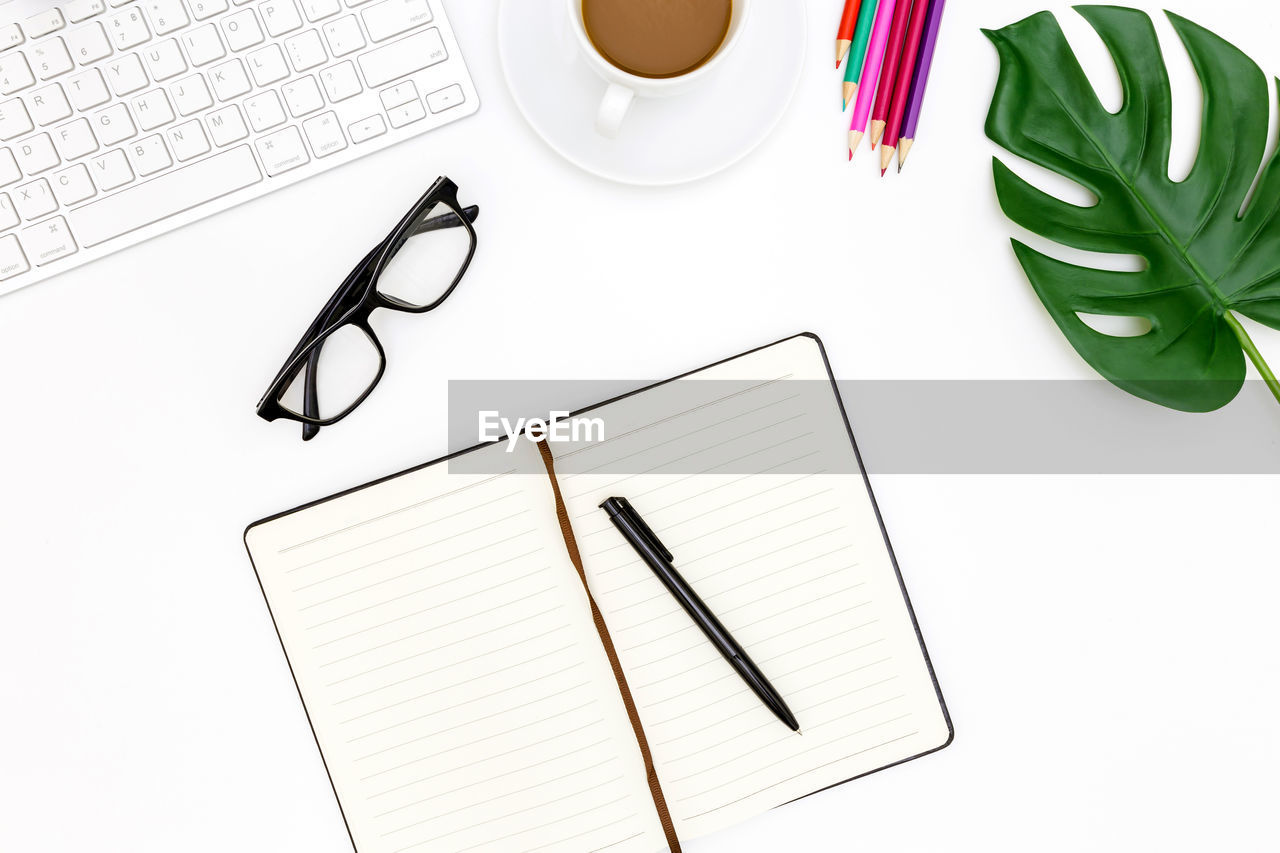 Directly above shot of eyeglasses and coffee cup on table