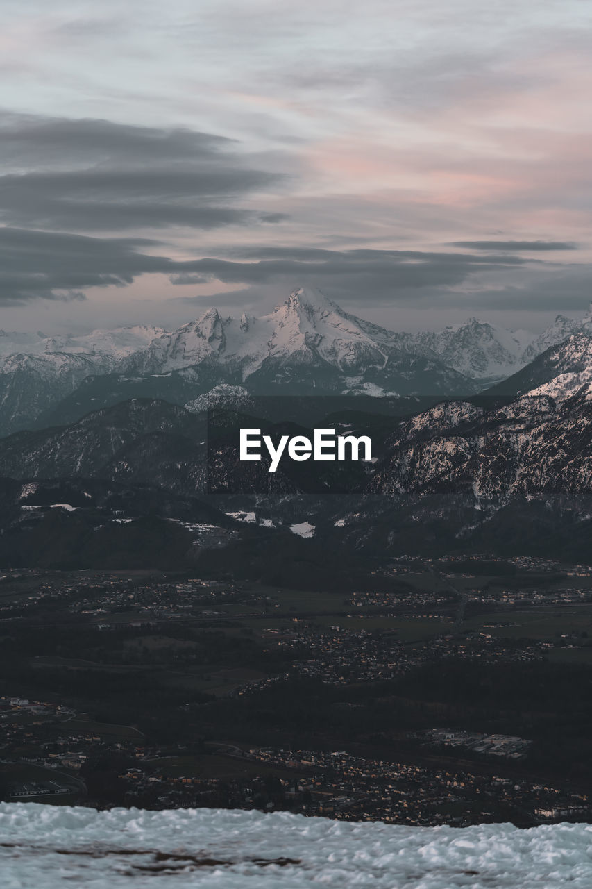 Aerial view of snowcapped mountains against sky during winter