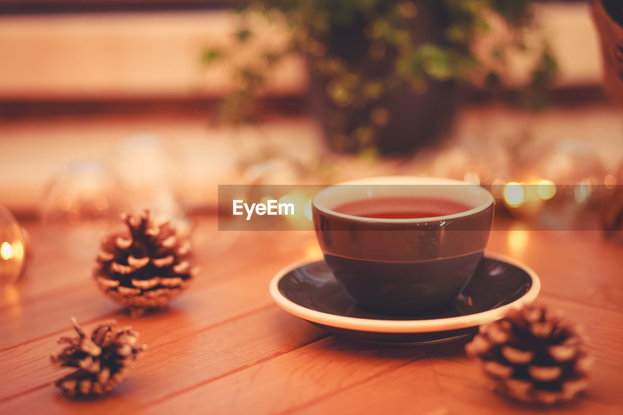 CLOSE-UP OF COFFEE ON TABLE AT HOME