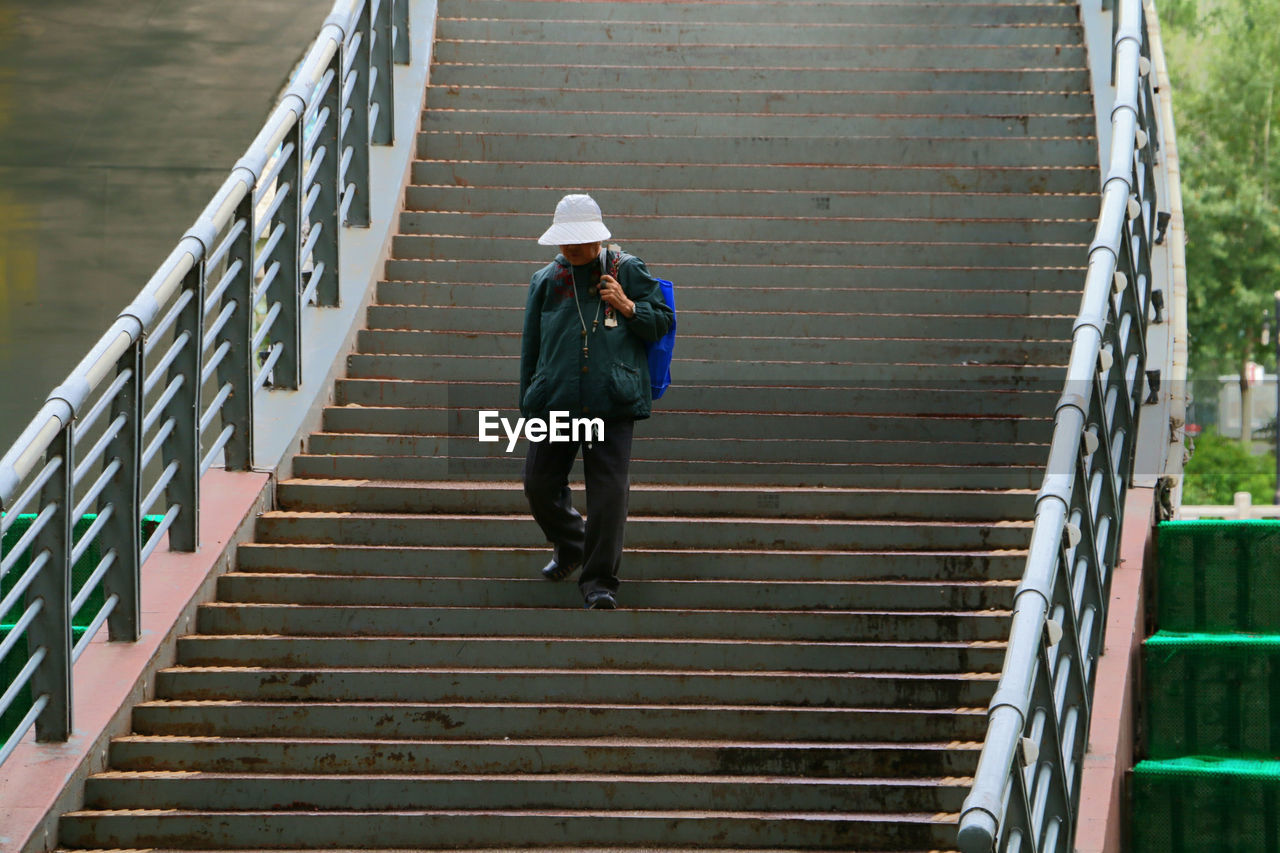 FULL LENGTH OF WOMAN ON STAIRS