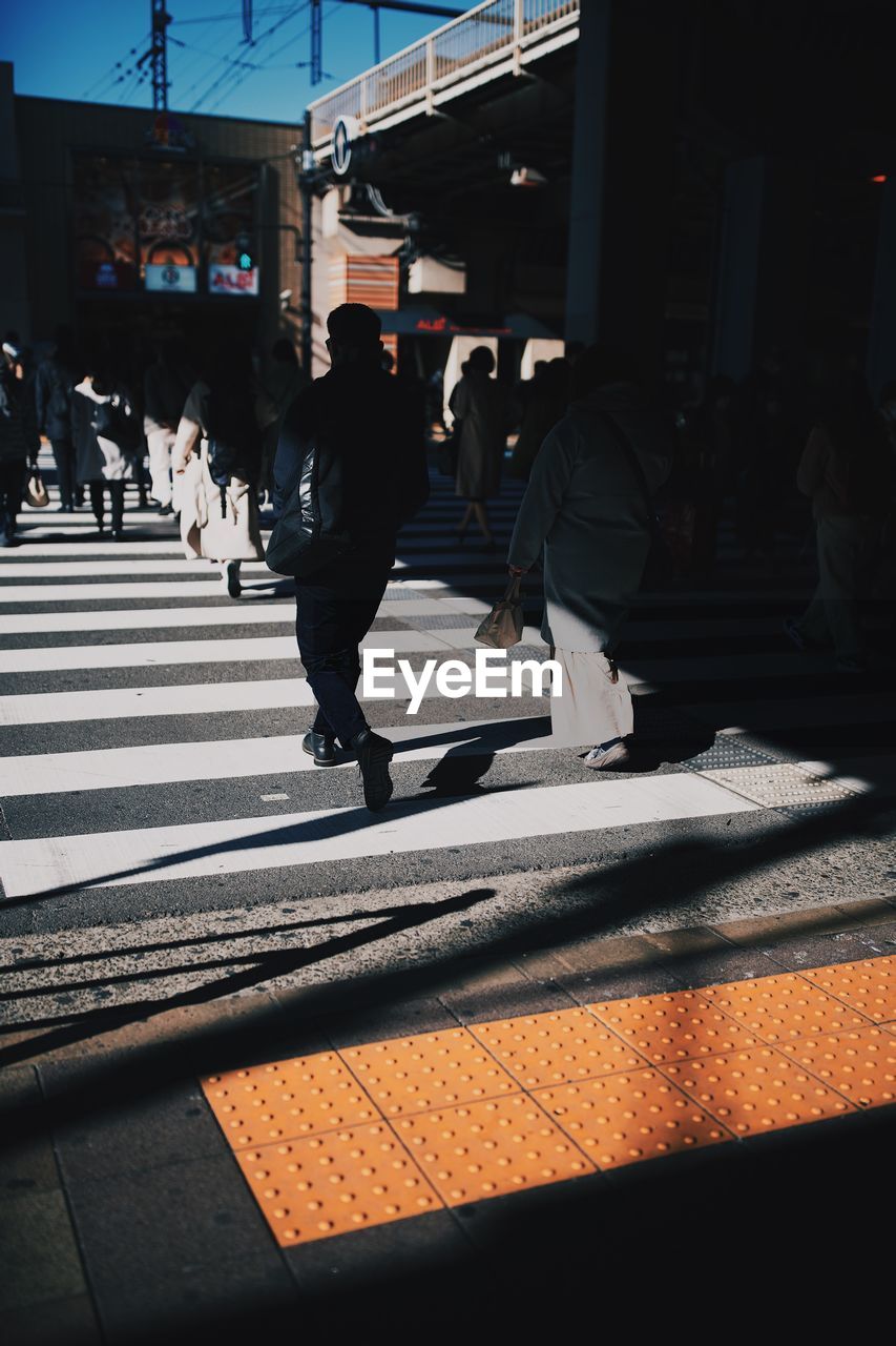 People crossing road in city