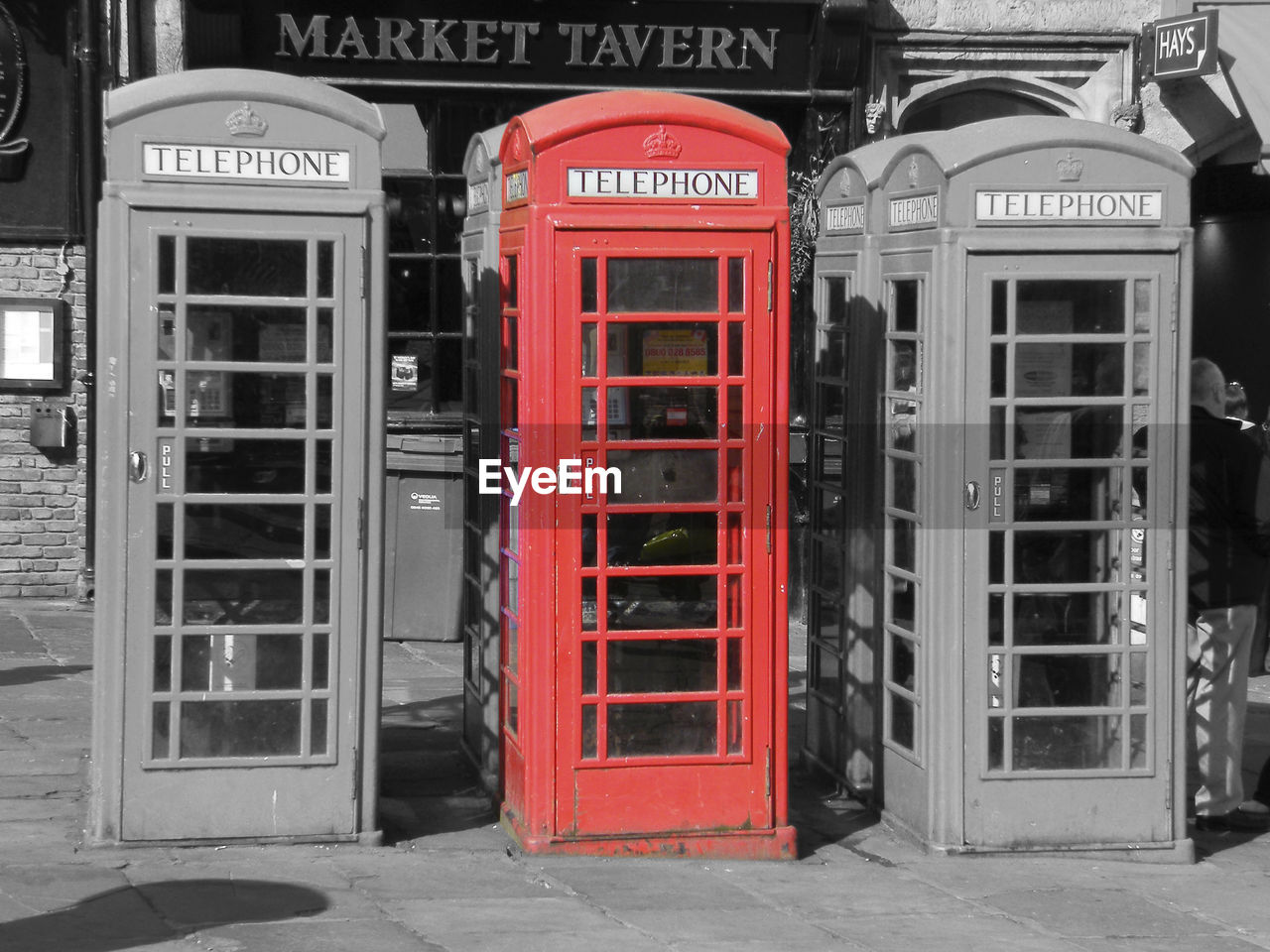 CLOSE-UP OF RED TELEPHONE BOOTH ON THE WALL