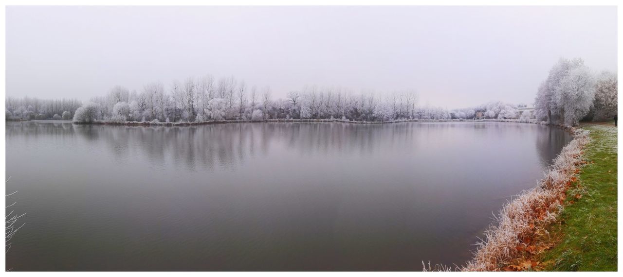 LAKE BY TREES AGAINST SKY