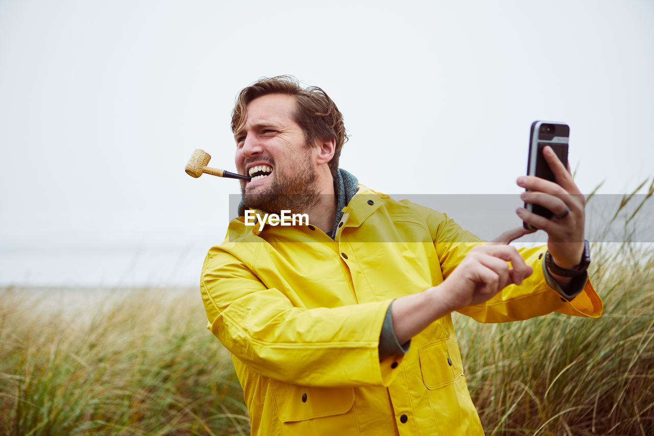 Man taking selfie at beach