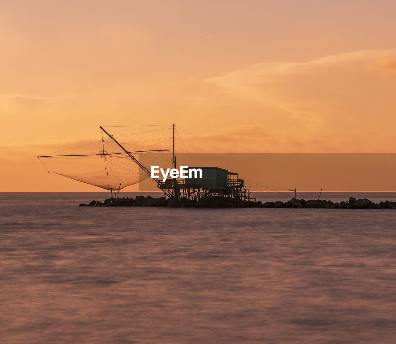 boats in sea against sky during sunset