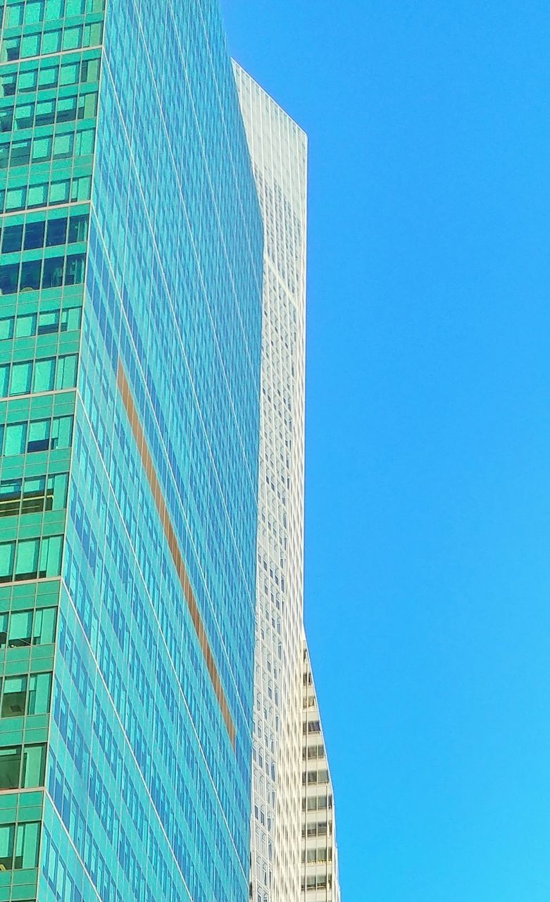 LOW ANGLE VIEW OF MODERN BUILDING AGAINST BLUE SKY