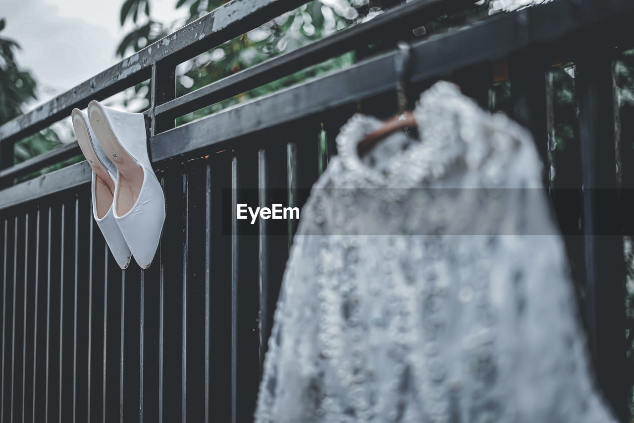 Close-up of clothes hanging on railing