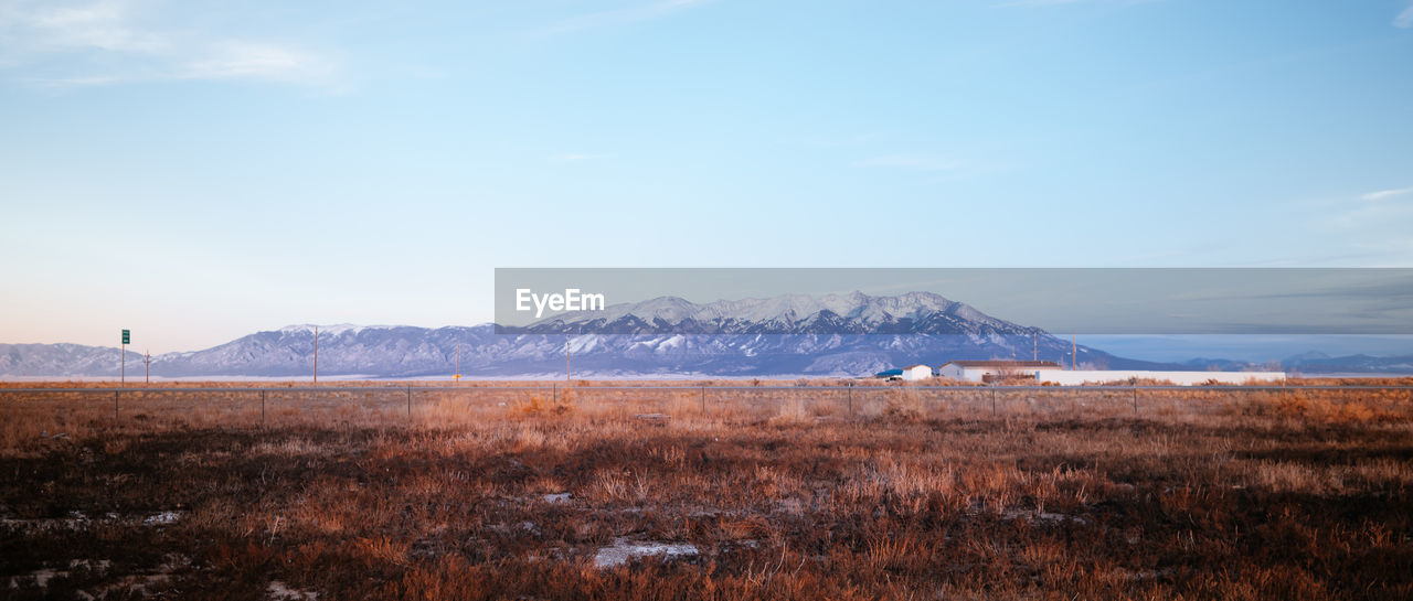 Low angle view of snowcapped mountains against sky